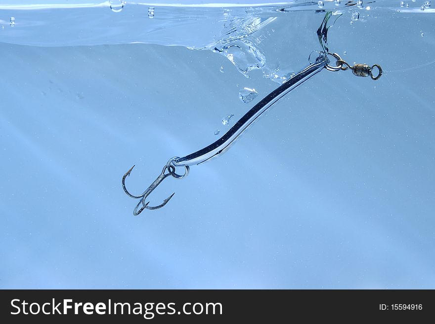 Metal fishing lure near surface of water