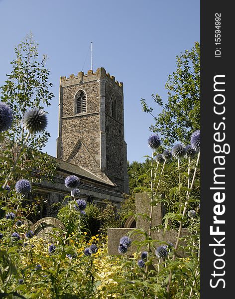 Historic British village church,with  garden flowers and stones. Historic British village church,with  garden flowers and stones.