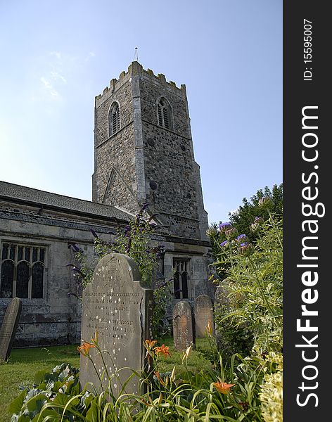 Old church in English village,with gravestones and flowers. Old church in English village,with gravestones and flowers.