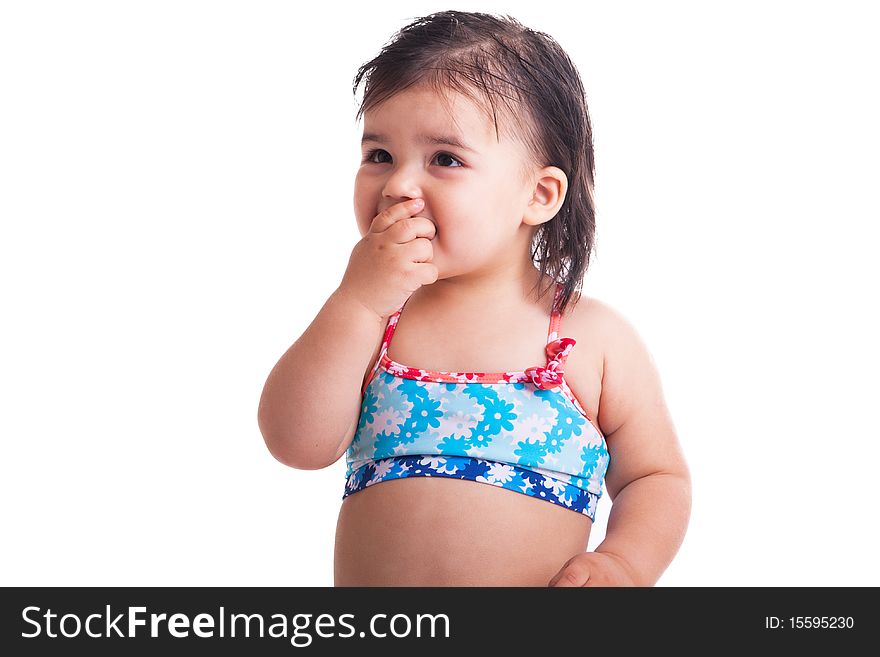 Little girl in swimming suit eating candy