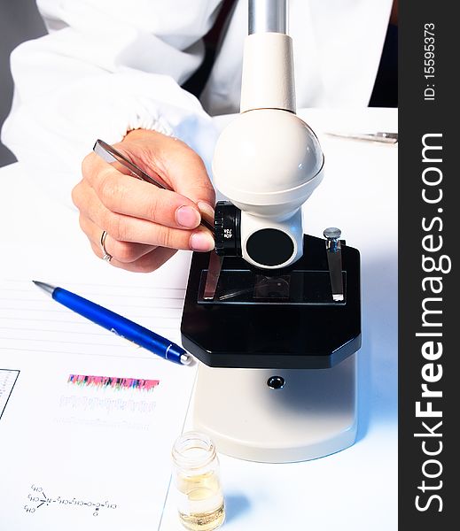 Microscope and female doctor's hand. Microscope and female doctor's hand
