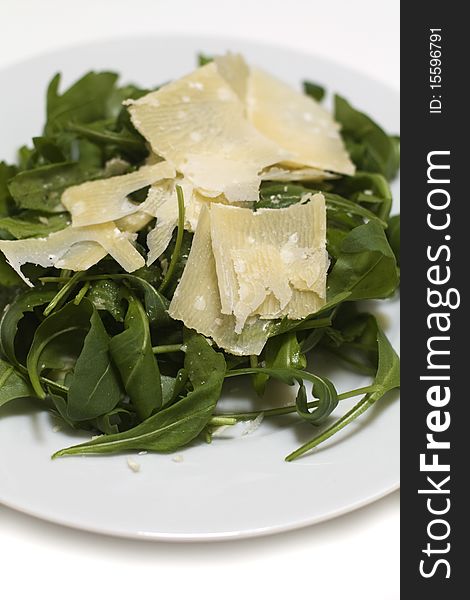 Fresh ruccola salad with parmesan chees on it