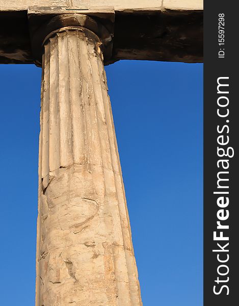 An ancient Greek column with Doric-type head. Background is the blue Athenian sky. An ancient Greek column with Doric-type head. Background is the blue Athenian sky.