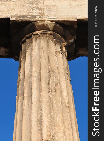 Close-up of an ancient Greek column with Doric-type head. Background is the blue Athenian sky. Close-up of an ancient Greek column with Doric-type head. Background is the blue Athenian sky.