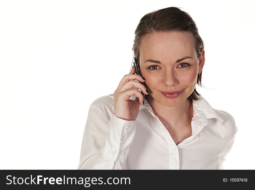 Beautiful girl speaking on the phone, seen against white background