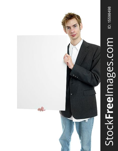 Young businessman holding a white cardboard sign with copyspace while standing up. Young businessman holding a white cardboard sign with copyspace while standing up