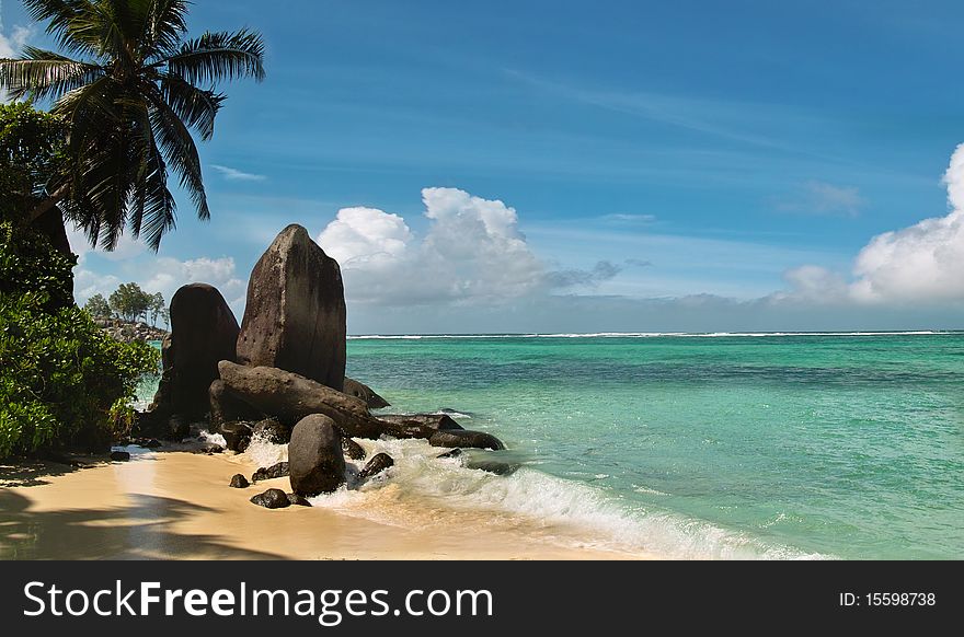 Beautiful waive is reached the beach of sunny paradise lagoon. The sky and tropical sea as background . The beautiful blue sky area is free for your text . Beautiful waive is reached the beach of sunny paradise lagoon. The sky and tropical sea as background . The beautiful blue sky area is free for your text .