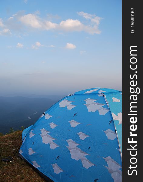 Camping on the top of mountain with blue tent