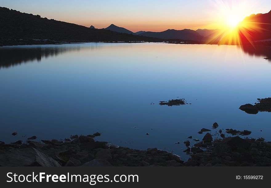 Sunrise over the mountain lake. Sunrise over the mountain lake.