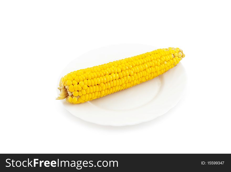 An image of boiled corn on white plate. An image of boiled corn on white plate.