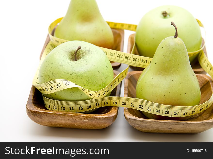 Apple and pear with tape measure. Apple and pear with tape measure