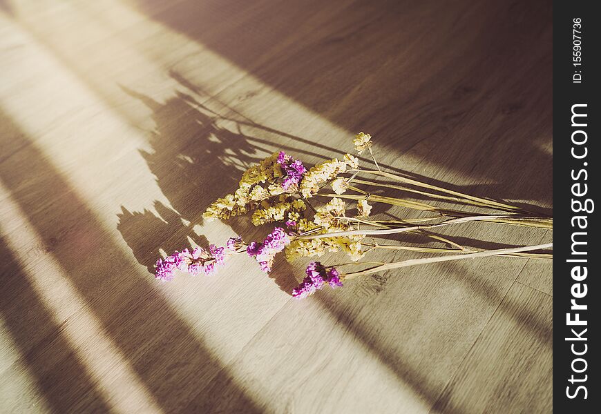 Flowers placed on a wooden floor with sunlight, Valentine concept