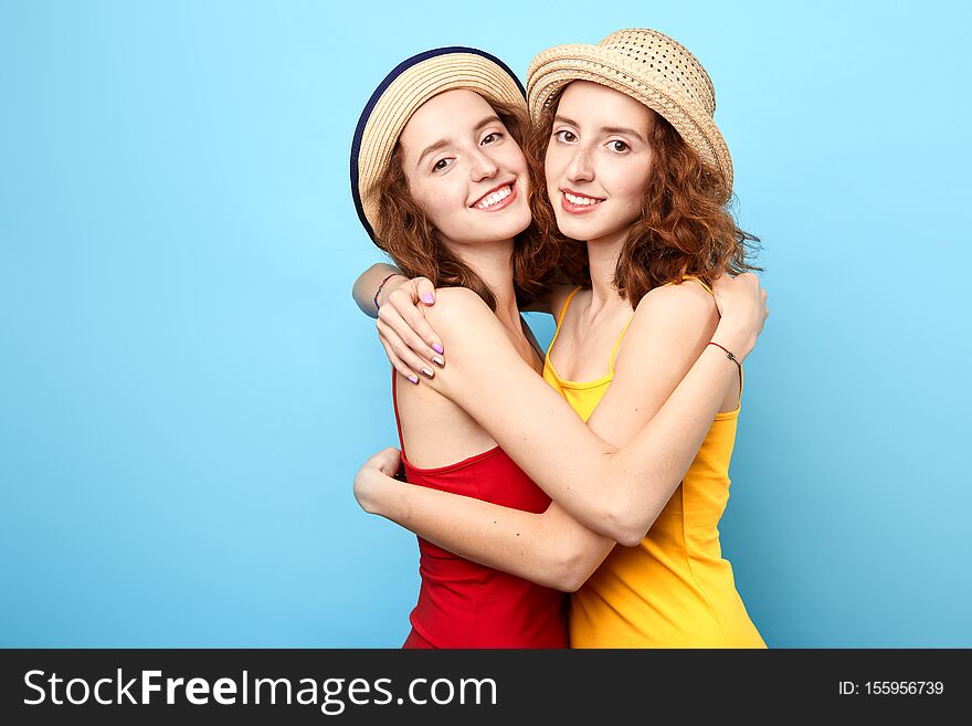 Good relationship between two sisters, support, love, friendship, isolated blue background