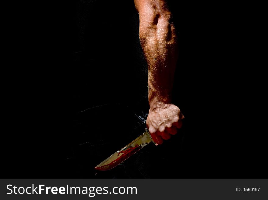 Photo of a guy holding a menacing divers knife. Photo of a guy holding a menacing divers knife.