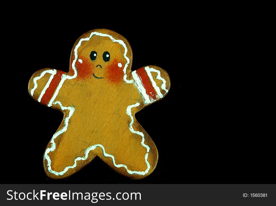 Gingerbread man as a child isolated on black space with room for text. Gingerbread man as a child isolated on black space with room for text