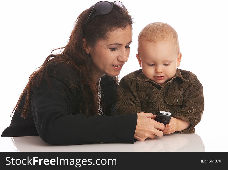 Mother and her baby-boy looking at a cell-phone. Mother and her baby-boy looking at a cell-phone