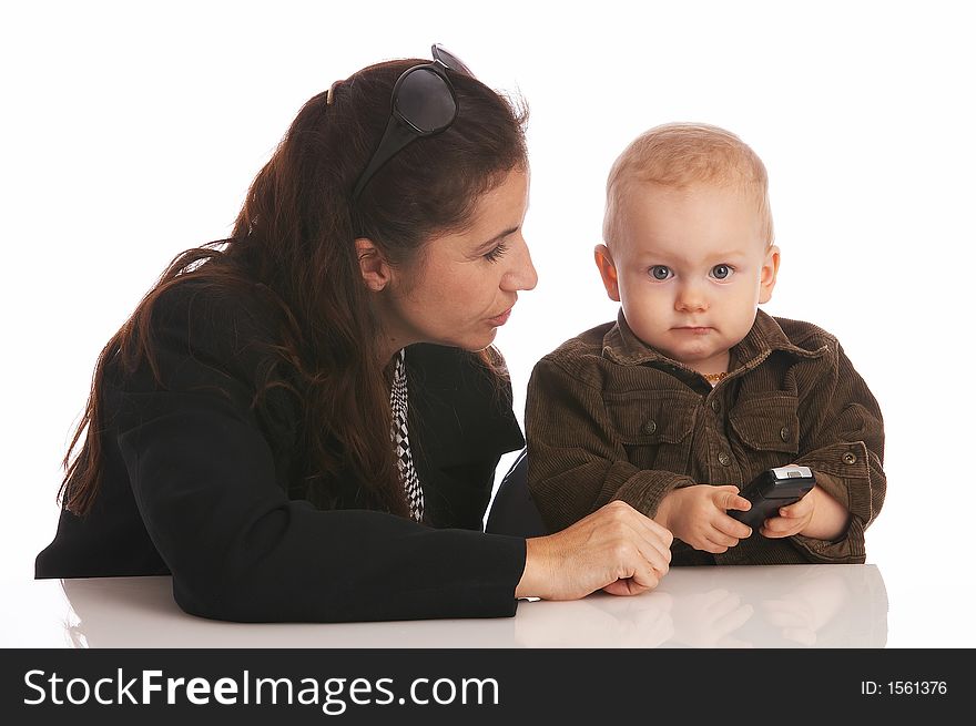 Mother looking at her baby-son which is holding a cell-phone. Mother looking at her baby-son which is holding a cell-phone