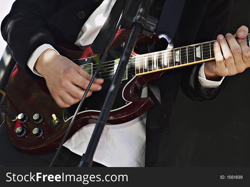 Guitar player with red electric guitar