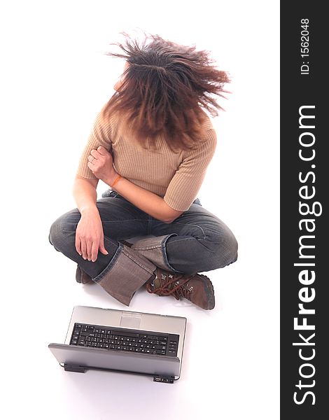 Woman sitting down on floor looking to her right side with a laptop over white background. Woman sitting down on floor looking to her right side with a laptop over white background