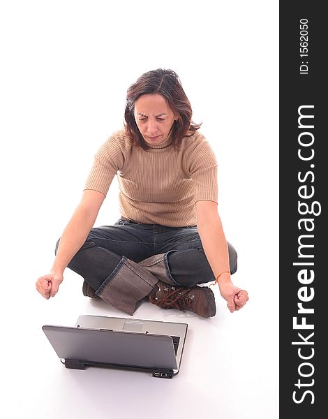 Woman sitting down on floor annoyed with something with a laptop over white background. Woman sitting down on floor annoyed with something with a laptop over white background