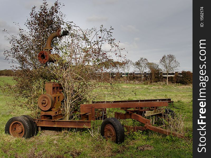 Derelict and rusting agricultural machine abandoned in an English Water Meadow. Derelict and rusting agricultural machine abandoned in an English Water Meadow.