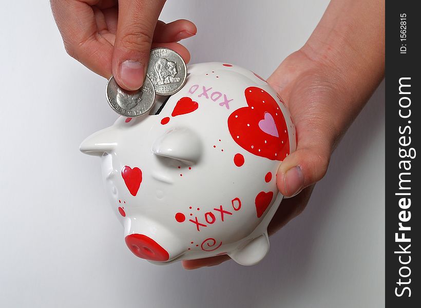 kid hands with piggy bank on white background