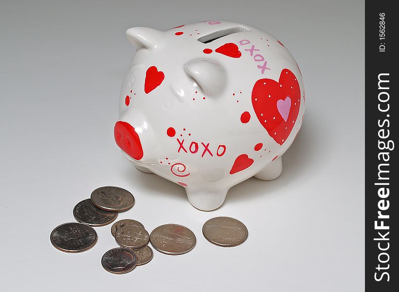 Piggy bank and coins on white background