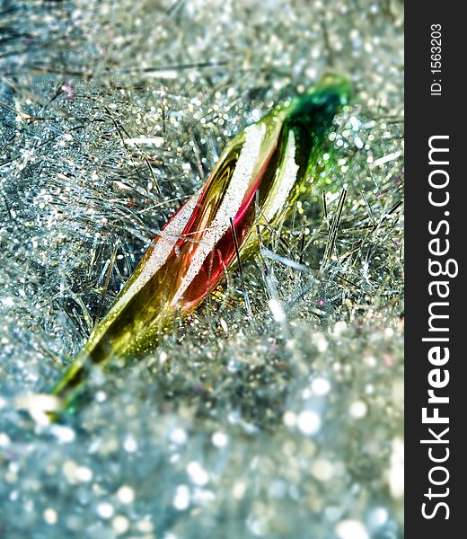 Partial blurred christmas decoration coloured icicle on glare background