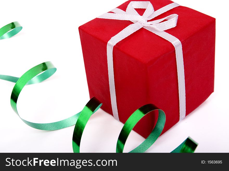 Red gift and green ribbon over white background. Red gift and green ribbon over white background