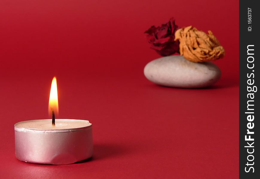 A romantic candle with flowers on the background, romantic mood