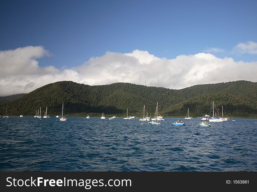 Beautiful hills and mountains surrounded by many ships. Beautiful hills and mountains surrounded by many ships