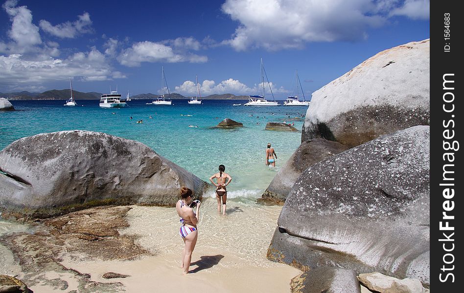 Young woman on a tropical beach with large granite rocks. Young woman on a tropical beach with large granite rocks