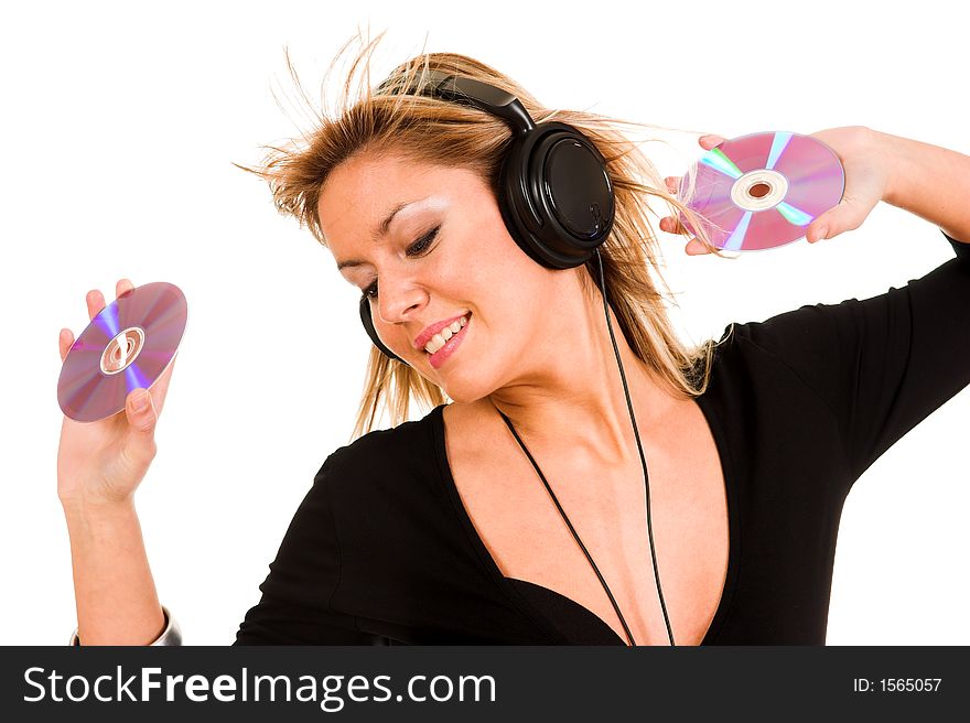 Beautiful young woman listening music in headphones and holding two CD