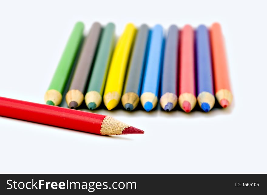 Colored pencils with one red pencil being sharper than the rest.