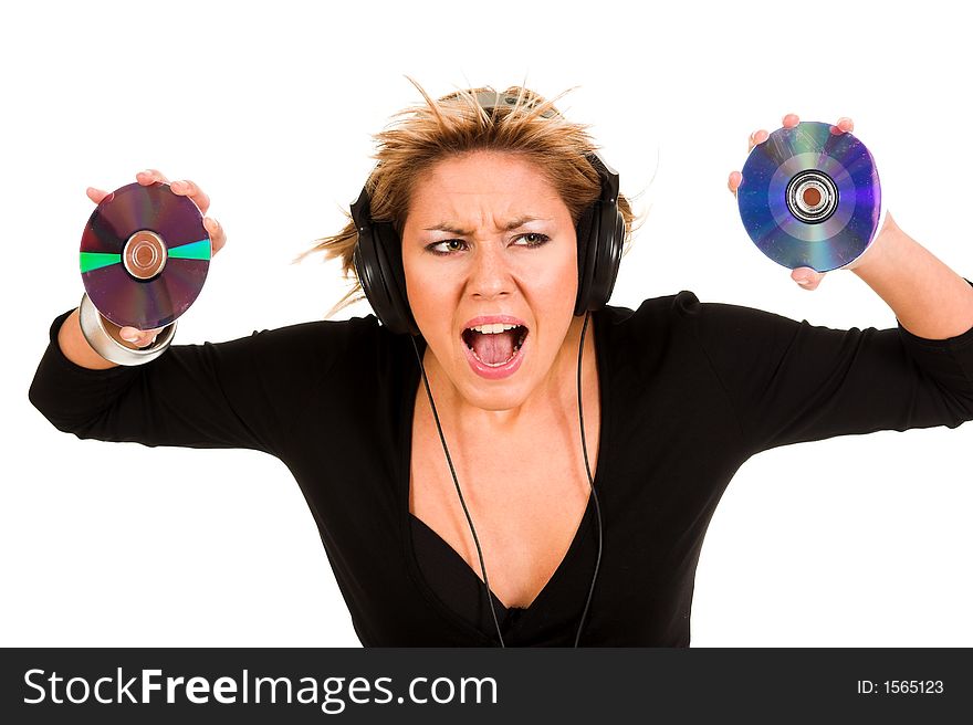 Beautiful young woman listening music in headphones and holding two CD