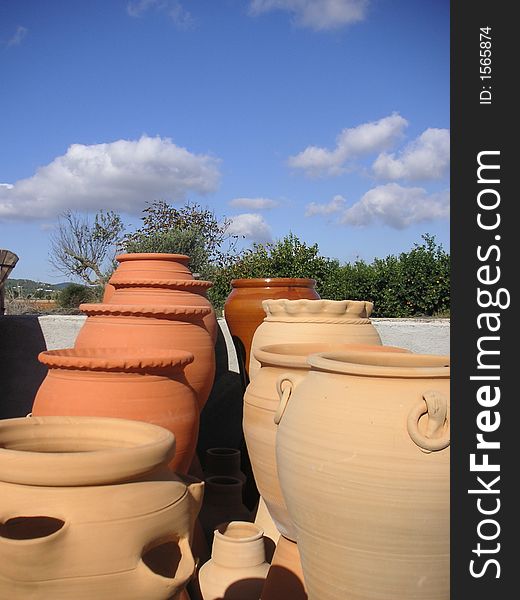 Spanish garden detail with terra-cotta pottery under a deep blue sky. Spanish garden detail with terra-cotta pottery under a deep blue sky