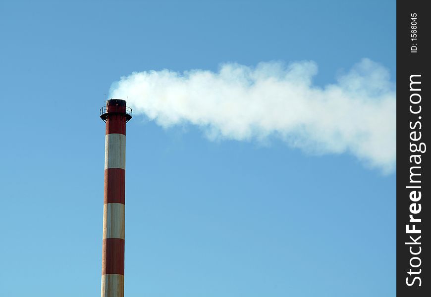 Industrial chimney in factory expelling smoke in the atmosphere