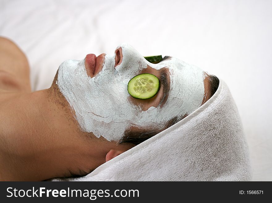 Someone having a cleansing mask with cucumber. Someone having a cleansing mask with cucumber