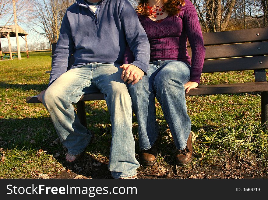 Young couple on park bench. Young couple on park bench