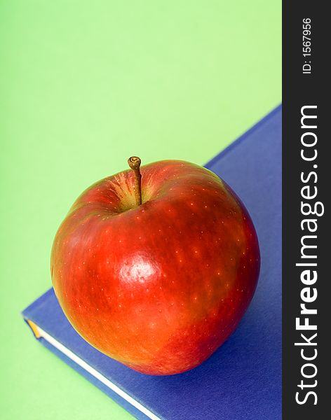 Apple on top of a book for school. Apple on top of a book for school
