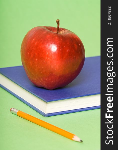 Blue book with red apple and pencil. Blue book with red apple and pencil