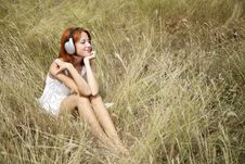 Beautiful Red-haired Girl At Grass With Headphones Royalty Free Stock Photo Beautiful Red-haired Girl At Grass With Headphones Royalty Free Stock Photo