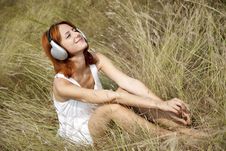 Beautiful Red-haired Girl At Grass With Headphones Royalty Free Stock Photos Beautiful Red-haired Girl At Grass With Headphones Royalty Free Stock Photos