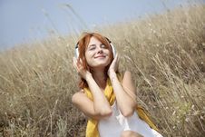 Beautiful Red-haired Girl At Grass With Headphones Stock Photography Beautiful Red-haired Girl At Grass With Headphones Stock Photography