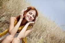 Beautiful Red-haired Girl At Grass With Headphones Stock Images Beautiful Red-haired Girl At Grass With Headphones Stock Images