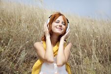 Beautiful Red-haired Girl At Grass With Headphones Royalty Free Stock Photography Beautiful Red-haired Girl At Grass With Headphones Royalty Free Stock Photography