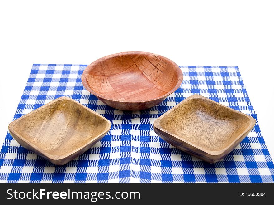 Wood bowl onto blue-white table cloth