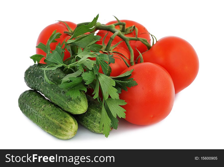 Tomatoes, cucumbers and parsley on a white background