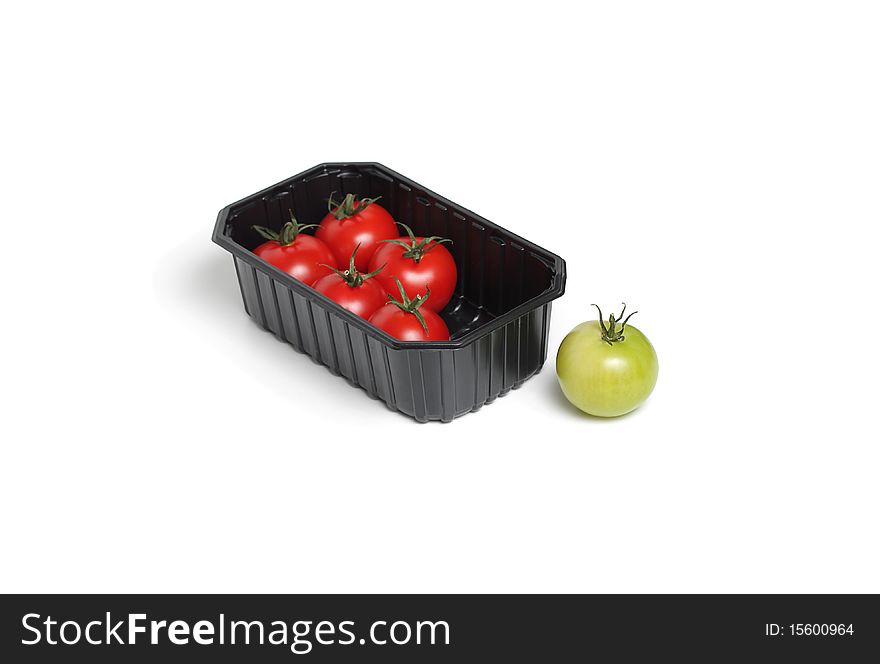 Organic red and green tomato in food container isolated on white background