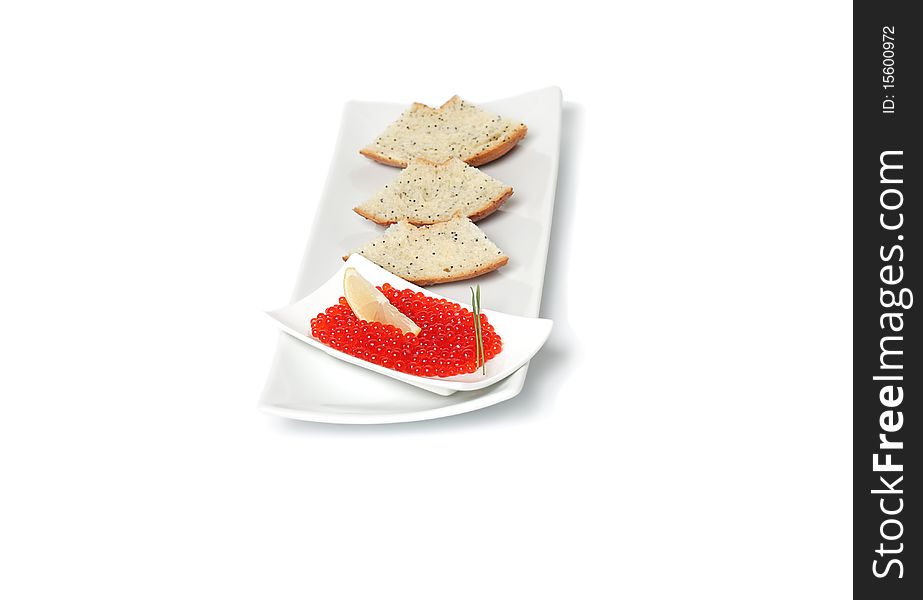 Red caviar  with sliced bread and lemon on plate isolated on white background